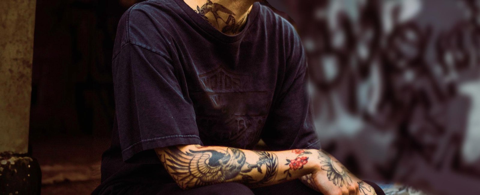 Man with Tattooed Arm and Neck Wearing a T-shirt Man with Tattooed Arm and Neck Wearing a T-shirt
